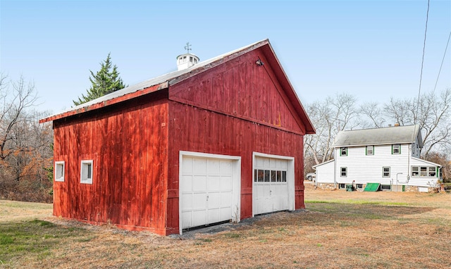 garage featuring a lawn