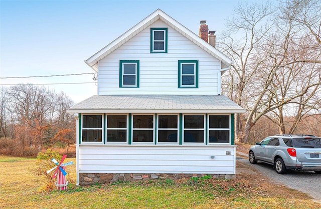 view of front of home with a sunroom