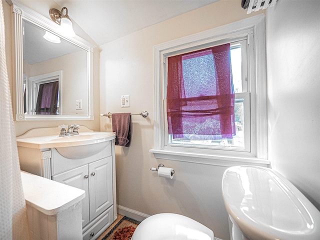 bathroom featuring vanity and vaulted ceiling