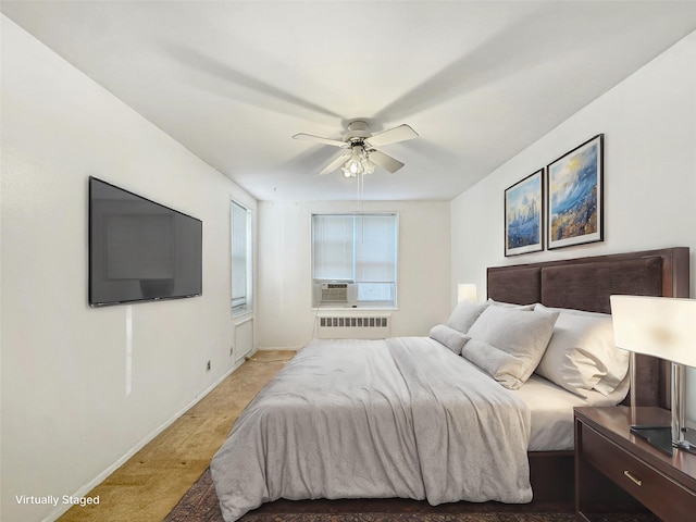 bedroom featuring ceiling fan and radiator