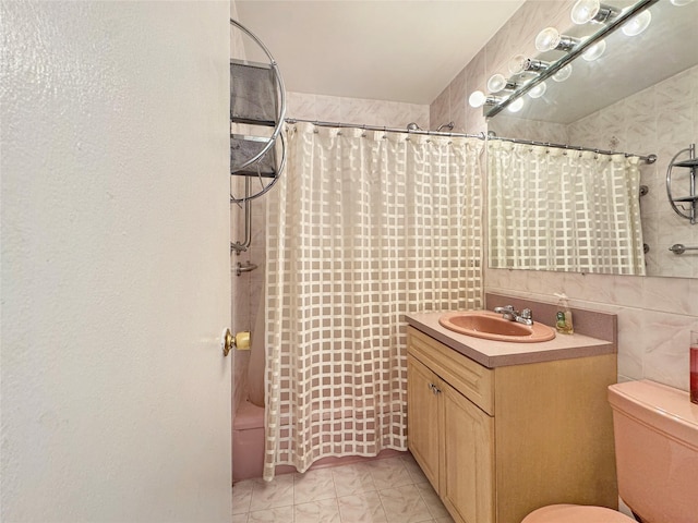 full bathroom with vanity, toilet, tile walls, and shower / tub combo with curtain