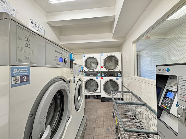 clothes washing area with washing machine and dryer and stacked washing maching and dryer