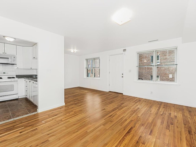 unfurnished living room with wood-type flooring