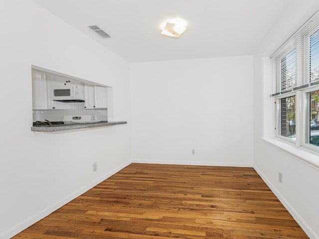 unfurnished dining area with hardwood / wood-style flooring