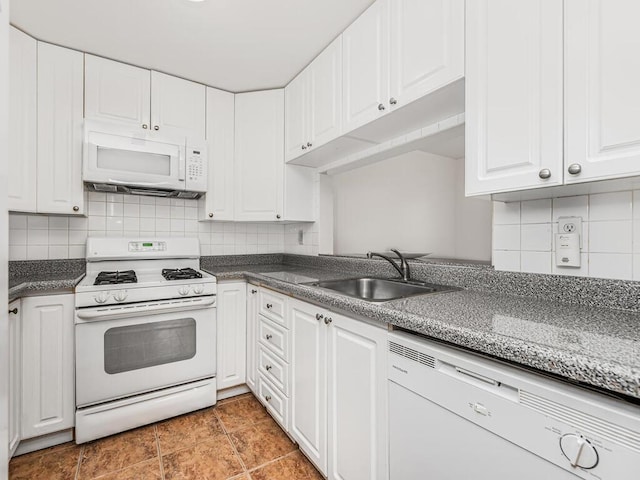 kitchen with white cabinets, decorative backsplash, white appliances, and sink