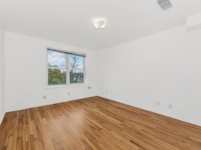 spare room featuring light hardwood / wood-style floors