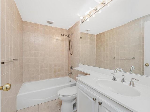 full bathroom featuring tile patterned flooring, vanity, toilet, and tiled shower / bath