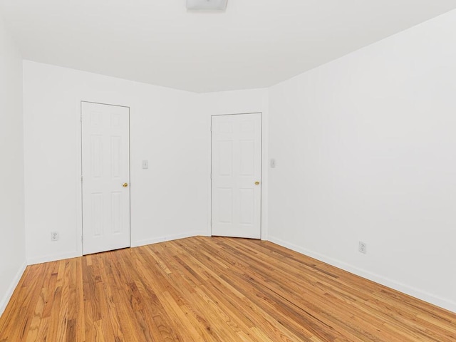 empty room with light hardwood / wood-style flooring