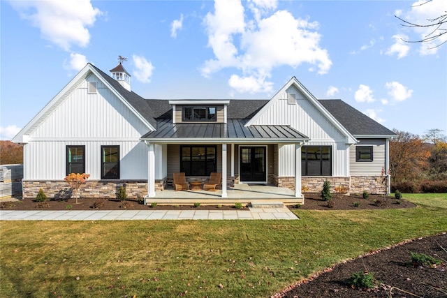 view of front of property with covered porch and a front lawn