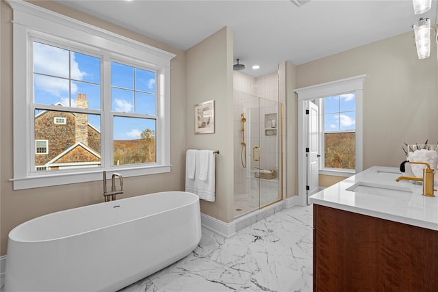 bathroom featuring shower with separate bathtub and vanity