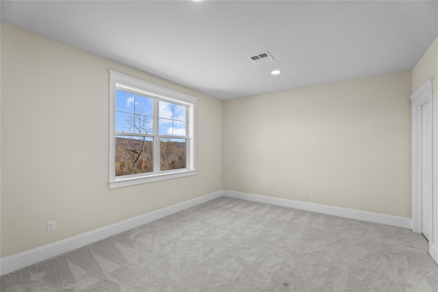 unfurnished room with light colored carpet