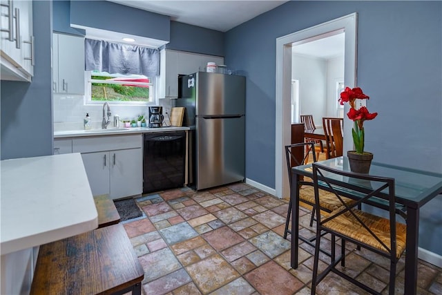 kitchen with dishwasher, white cabinets, and stainless steel fridge