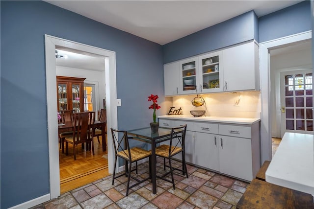 kitchen with backsplash and white cabinets