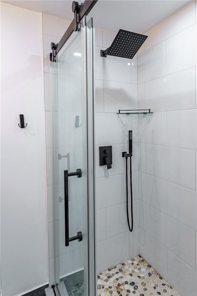 bathroom with a shower with door