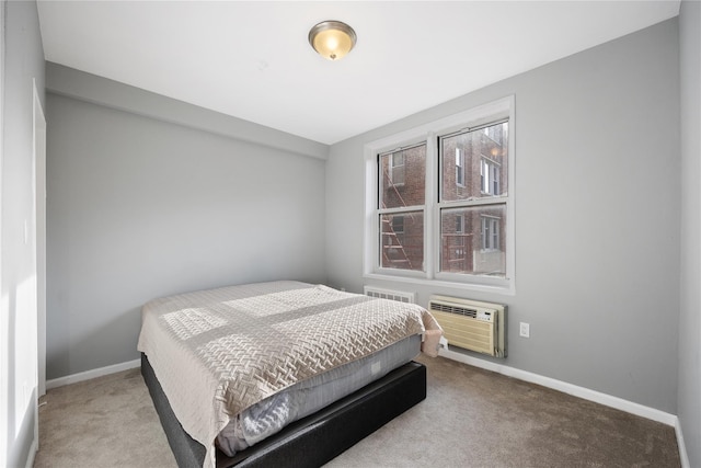 bedroom with a wall mounted AC and light colored carpet