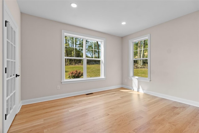 spare room featuring light wood-type flooring