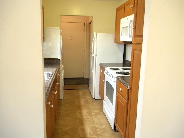 kitchen featuring sink, light tile patterned floors, and white appliances