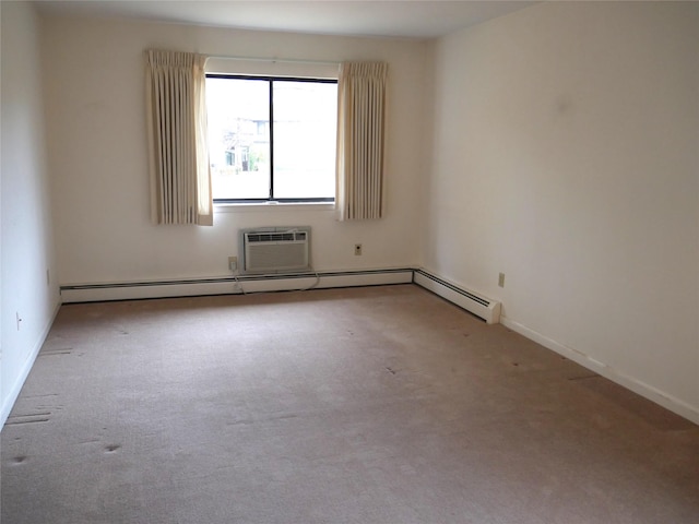 carpeted spare room with a wall unit AC and baseboard heating