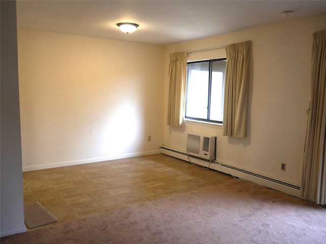 carpeted spare room with a baseboard heating unit