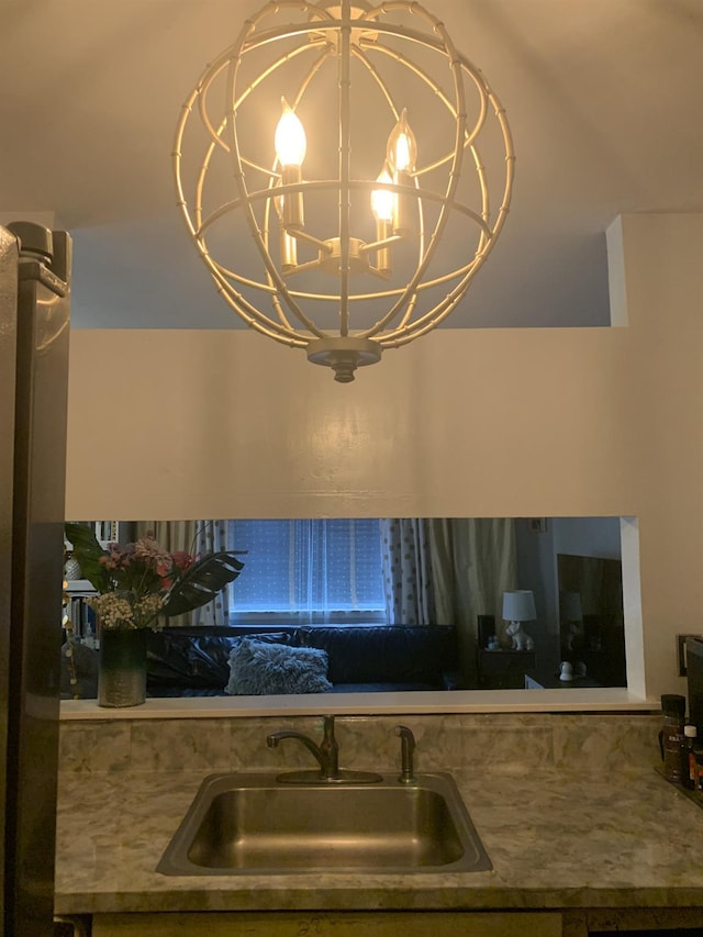 kitchen featuring an inviting chandelier and sink