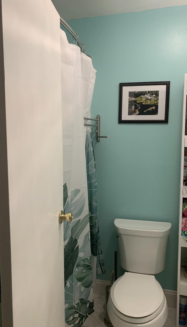 bathroom with tile patterned flooring and toilet