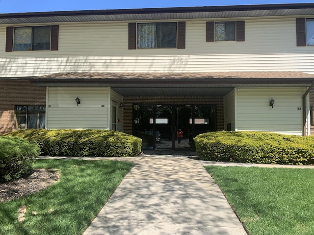 615 Broadway Unit 81, Amityville, NY 11701 - view of front of house featuring brick siding and a front yard