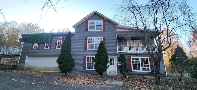 front of property with a balcony and a garage