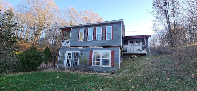 rear view of property with a lawn