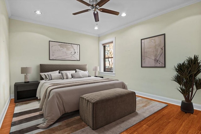 bedroom featuring wood-type flooring, ornamental molding, and ceiling fan