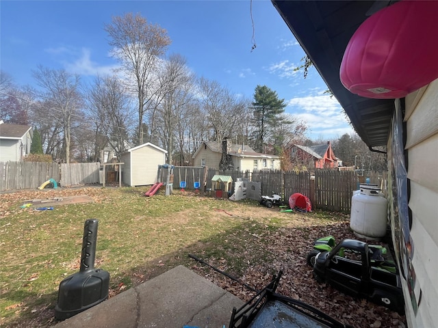 view of yard with a playground and a shed