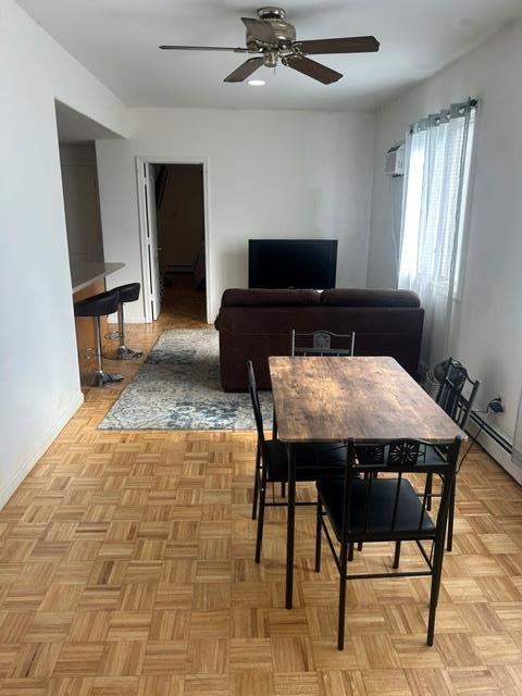 dining area featuring light parquet flooring and ceiling fan