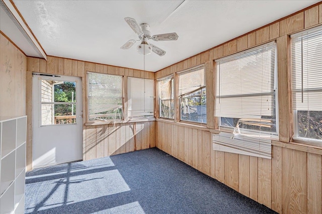 sunroom featuring ceiling fan