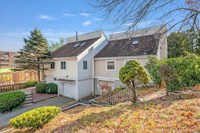 rear view of house with a garage