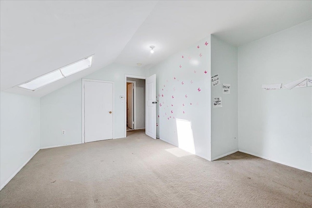 bonus room featuring light carpet and vaulted ceiling with skylight