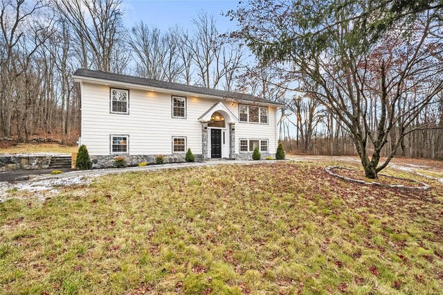 split foyer home with a front lawn