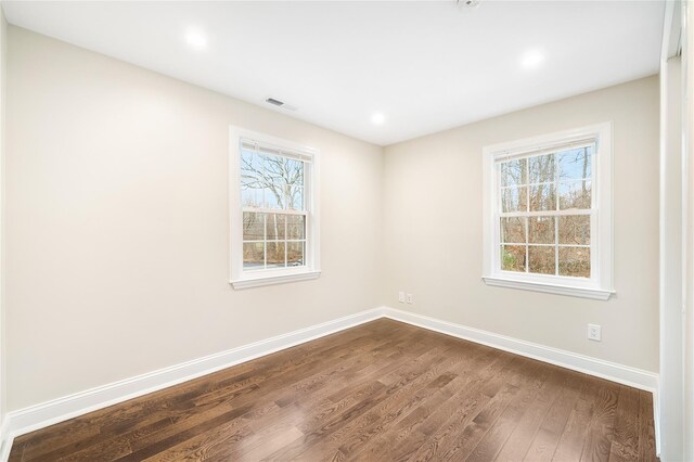 empty room featuring dark hardwood / wood-style flooring
