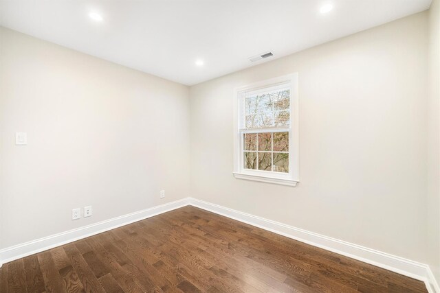 empty room with hardwood / wood-style flooring