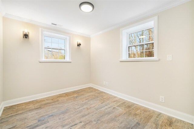 spare room with wood-type flooring and ornamental molding