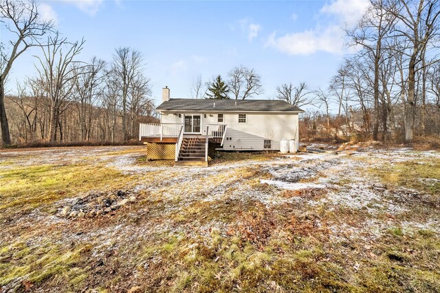 rear view of property featuring a wooden deck