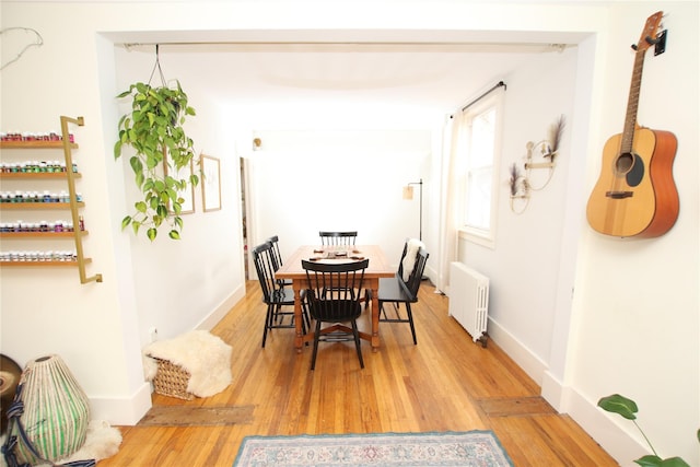 19-21 Moore Ave, Chatham, NY 12037 - dining area with radiator, wood finished floors, and baseboards