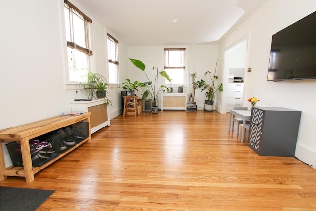 interior space featuring radiator heating unit and light hardwood / wood-style floors