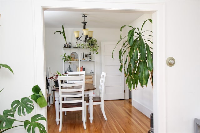 dining room featuring hardwood / wood-style flooring and a notable chandelier