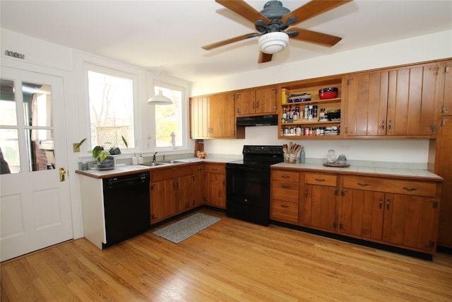 kitchen featuring black appliances, sink, light hardwood / wood-style flooring, ceiling fan, and decorative light fixtures