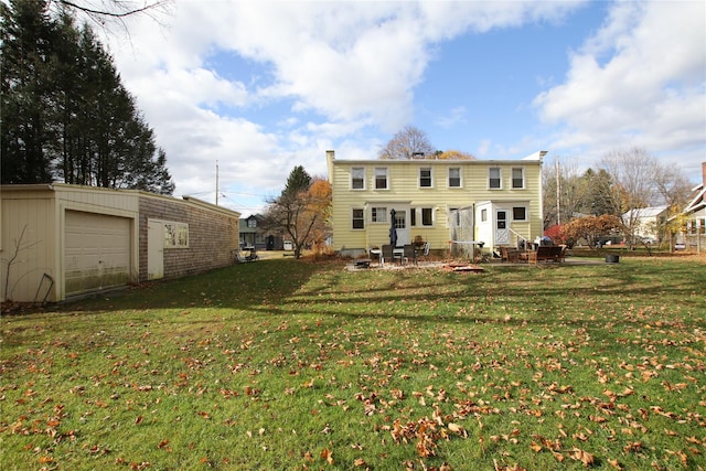 rear view of house with a lawn and a garage