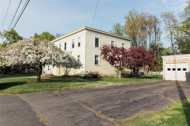 19-21 Moore Ave, Chatham, NY 12037 - view of side of home with asphalt driveway, a garage, and a yard