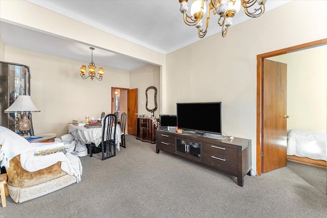 carpeted living room featuring a chandelier