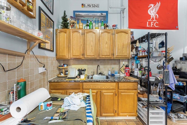 kitchen with sink, backsplash, and light tile patterned flooring