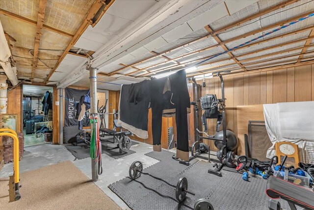 workout area featuring wooden walls