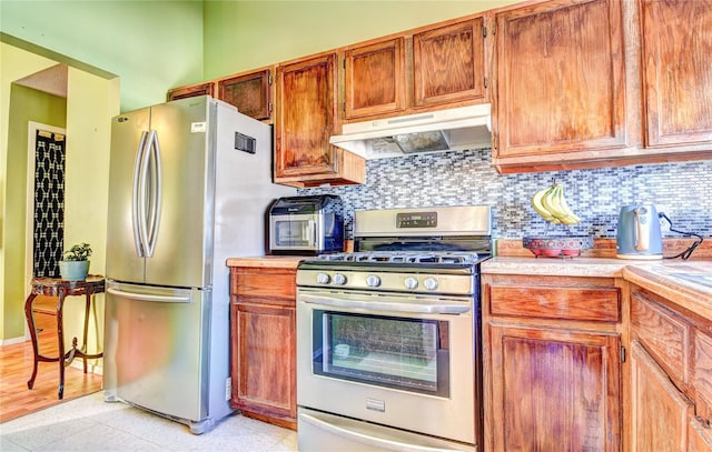 kitchen with decorative backsplash and appliances with stainless steel finishes