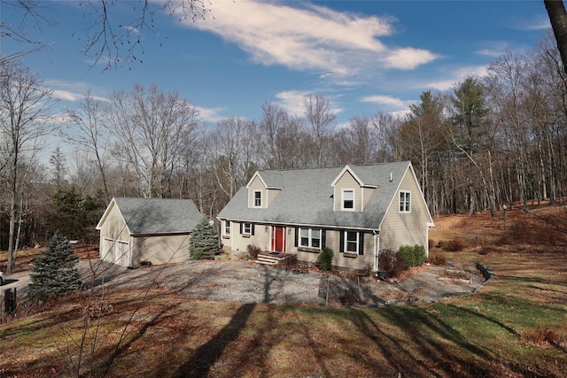 cape cod-style house with a front yard